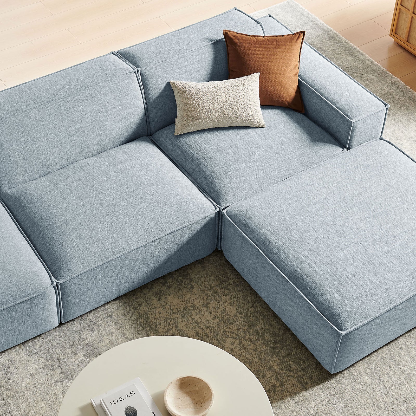 Sky blue fabric, plush cushions, and accent pillows creating a soft, inviting lounge corner || EEI-7409-SKY || detail_room