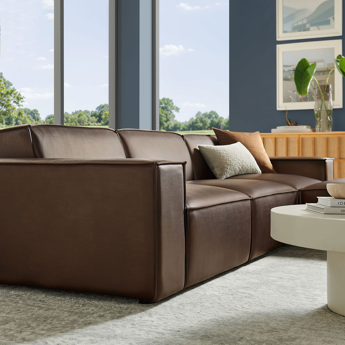 Espresso vegan leather sofa modules with accent pillows emphasize clean lines and tailored piping detail || EEI-7410-ESP || front_angle_partial_room