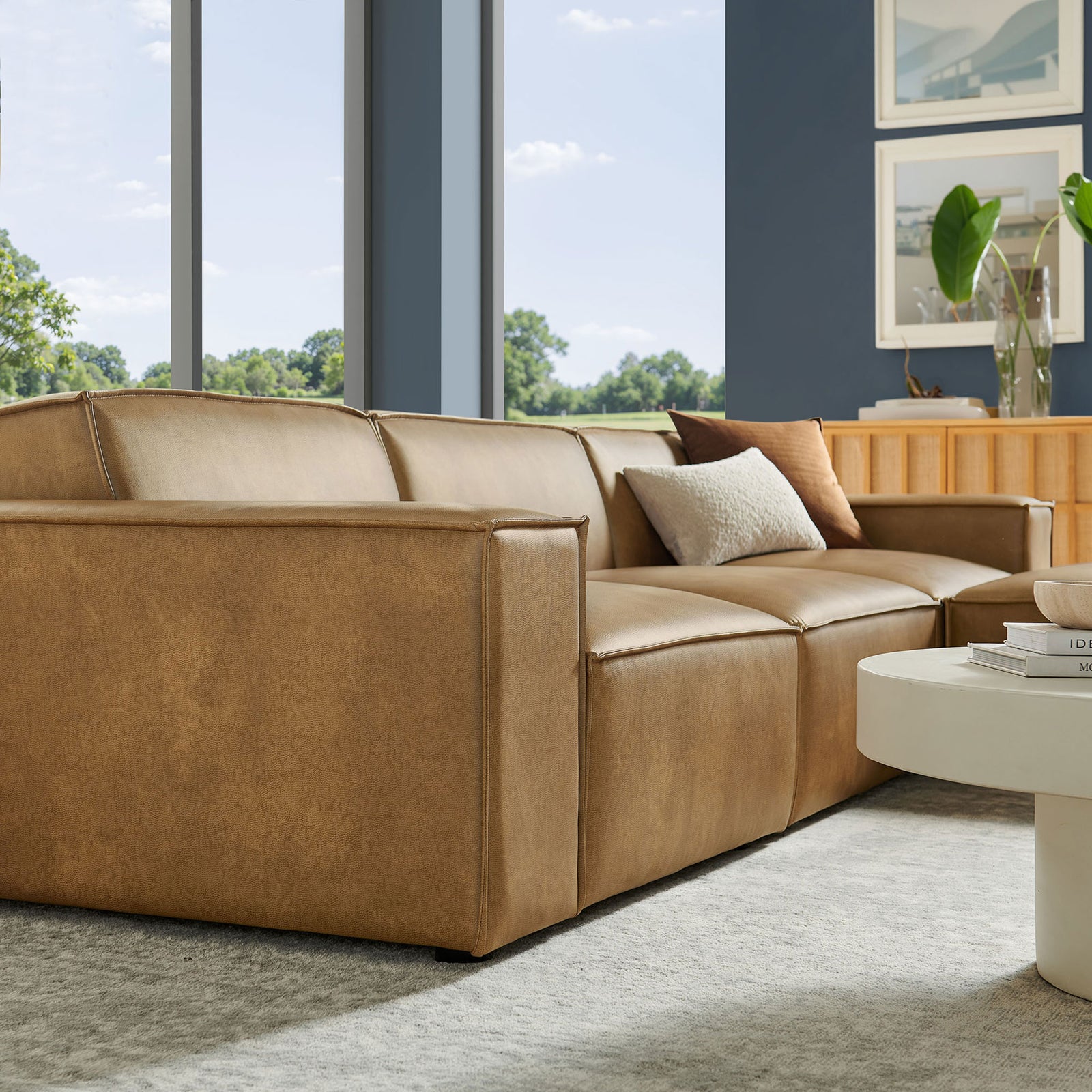 Toast vegan leather sectional showcasing wide track arms and generous seat depth in a modern living room || EEI-7410-TST || detail_room