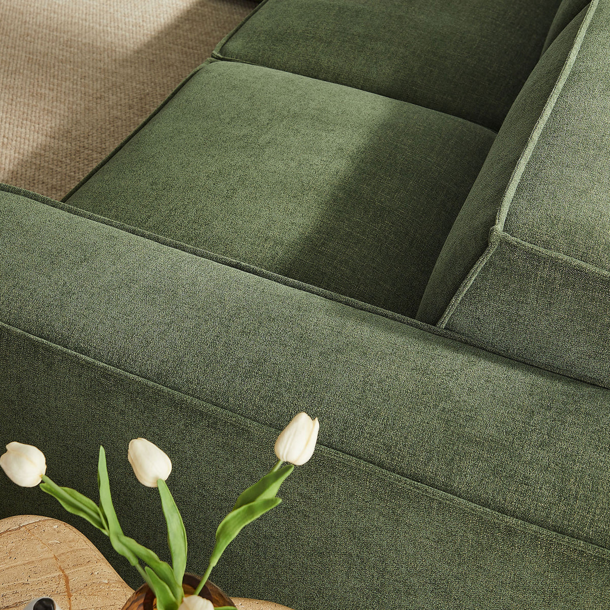 Foliage green armrest and cushions highlighting the sofa's soft performance fabric and refined French piping. || EEI-7411-FOL || detail_room