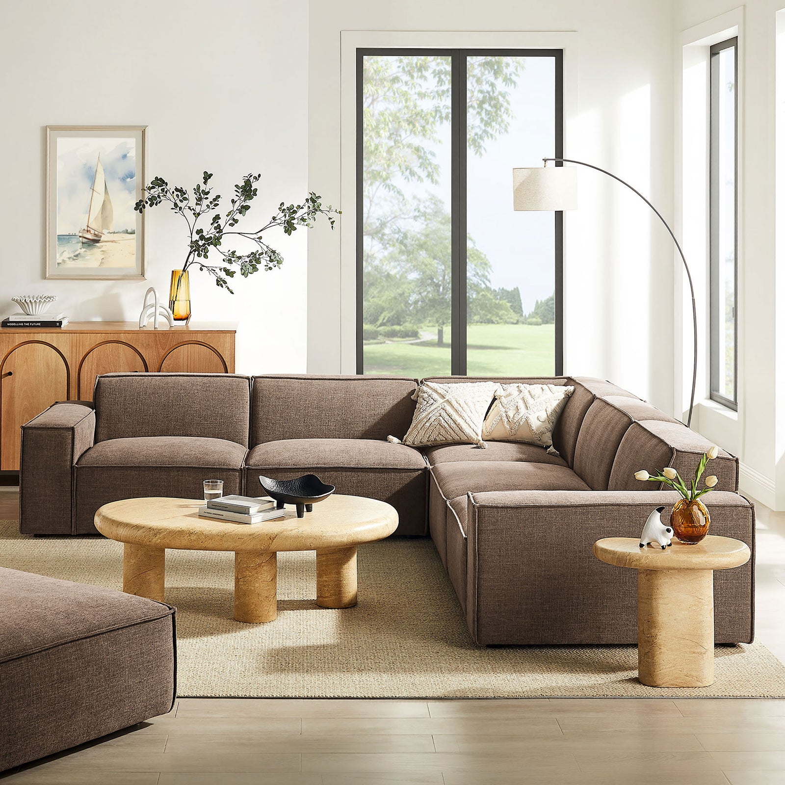 Mocha modular sectional anchored in a bright living room with coordinating wood tables and floor lamp || EEI-7411-MOC || front_angle_room
