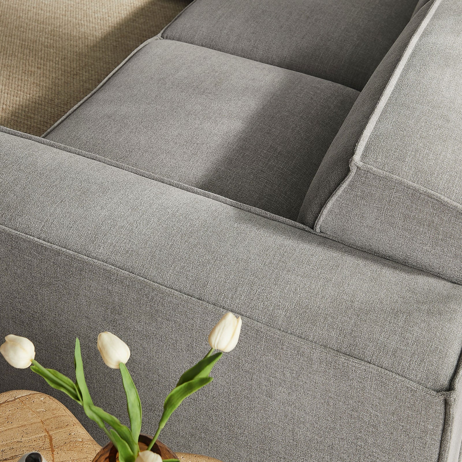 Close-up of the sofa arm and seat cushions highlighting the soft texture and tailored piping || EEI-7411-PEW || detail_room