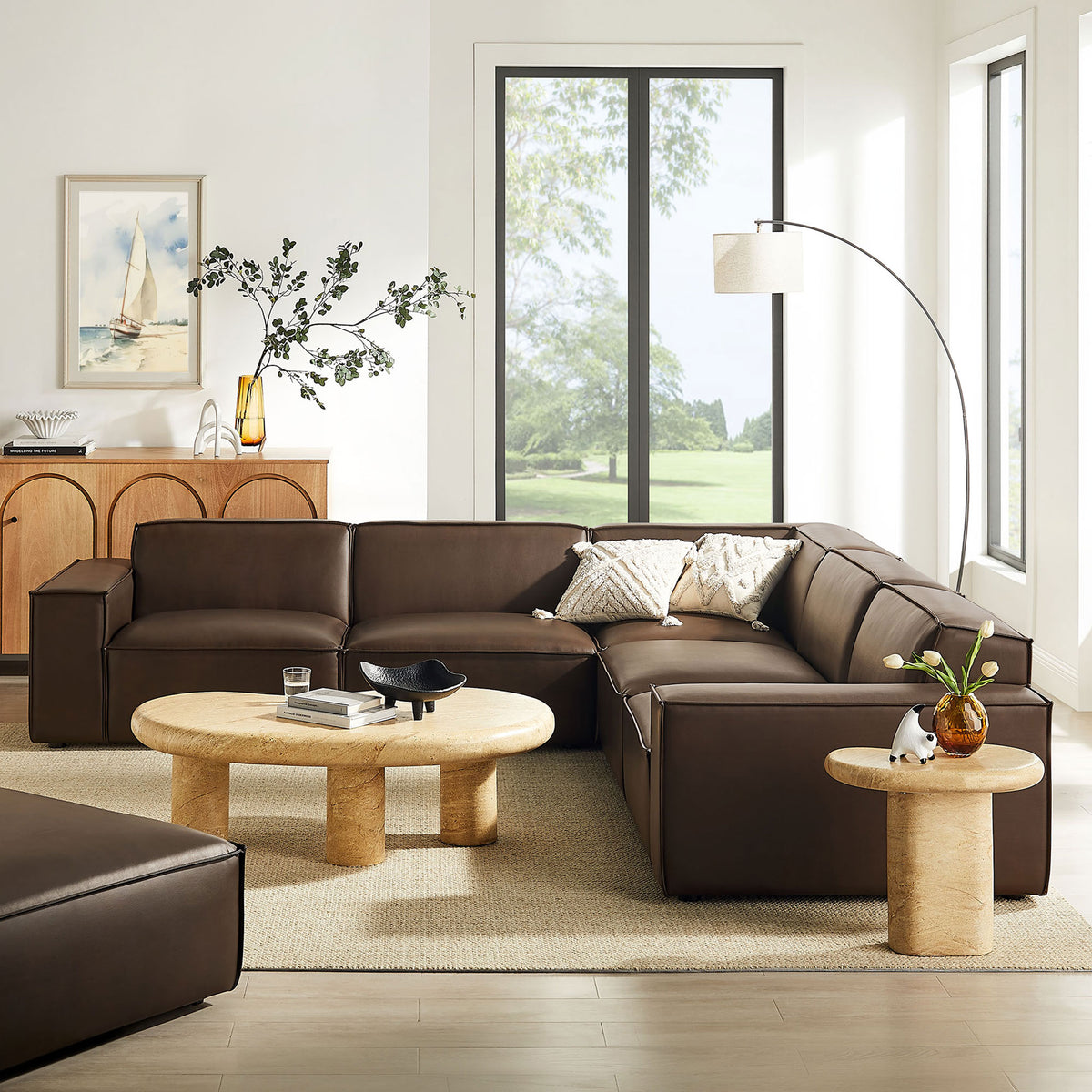 Espresso modular sectional anchors a bright living room with soft neutrals, rounded tables, and airy decor || EEI-7412-ESP || front_angle_room