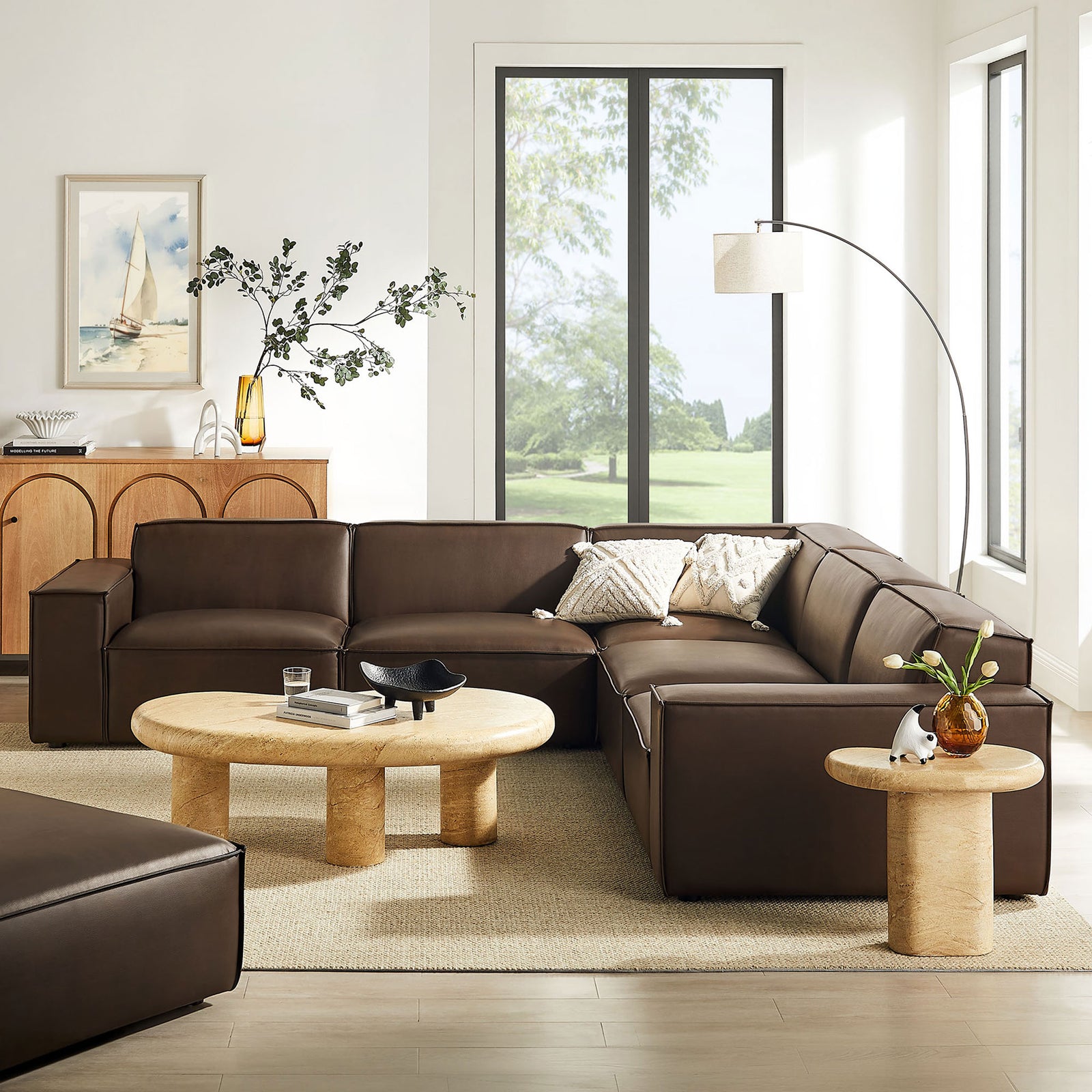 Espresso modular sectional anchors a bright living room with soft neutrals, rounded tables, and airy decor || EEI-7412-ESP || front_angle_room