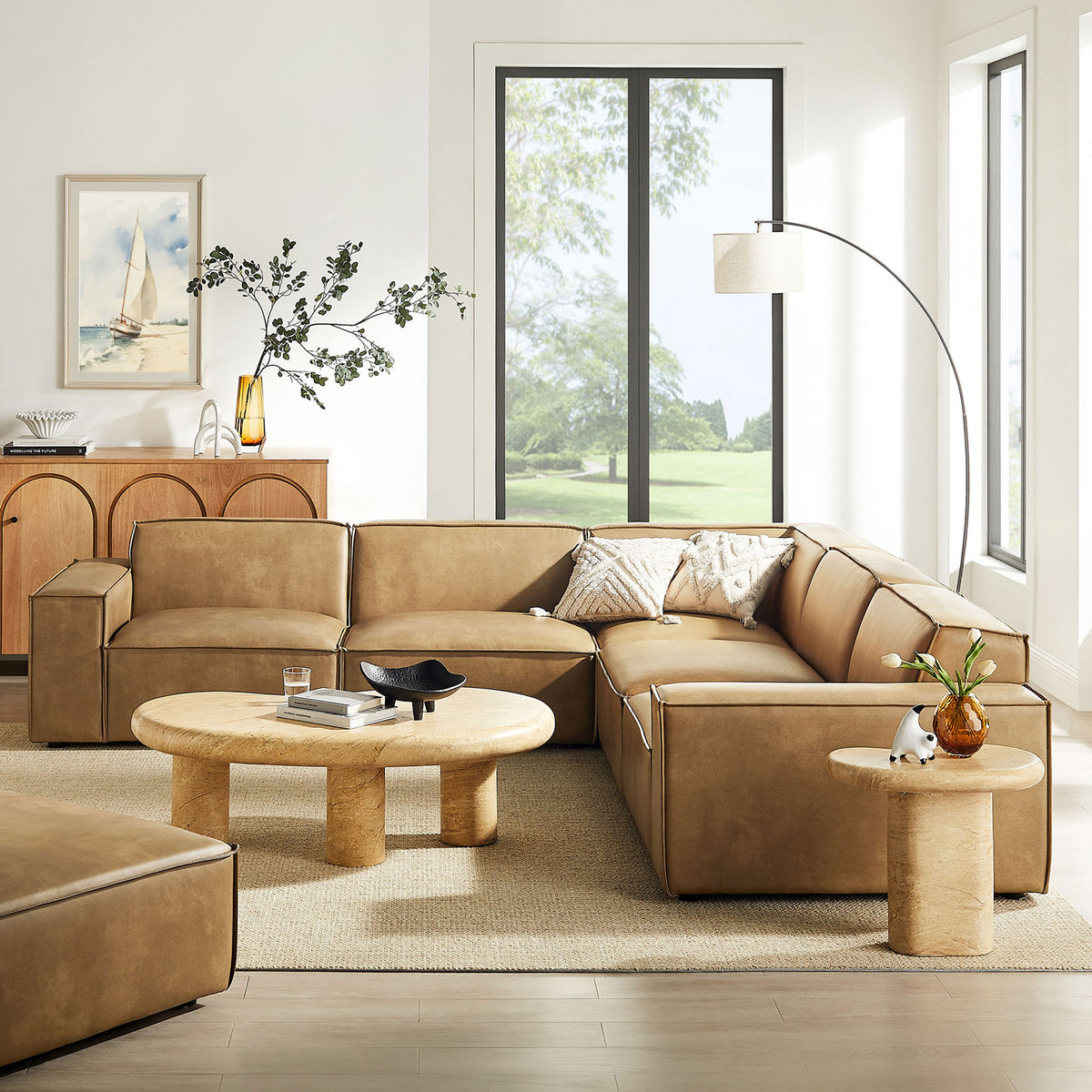 Toast vegan leather modular sectional anchors a bright living room with coordinating modern decor || EEI-7412-TST || front_angle_room