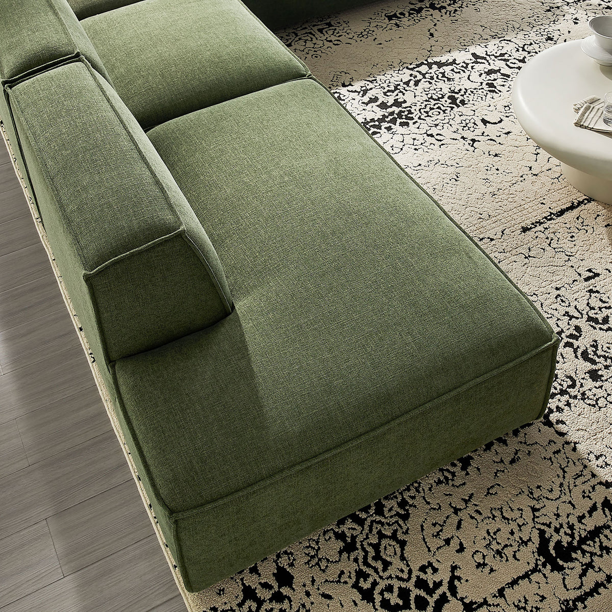 Green performance fabric chaise section with deep seat cushion and crisp French piping detail. || EEI-7413-FOL || detail_room