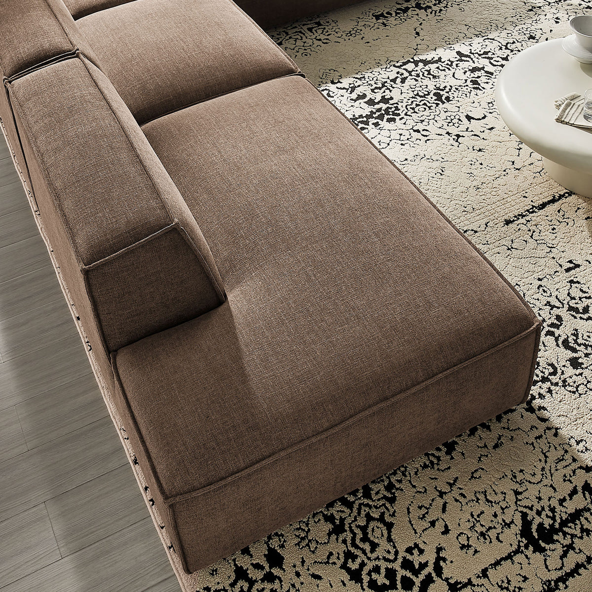 Mocha chaise cushion with tailored seams resting over a patterned area rug || EEI-7413-MOC || detail_room