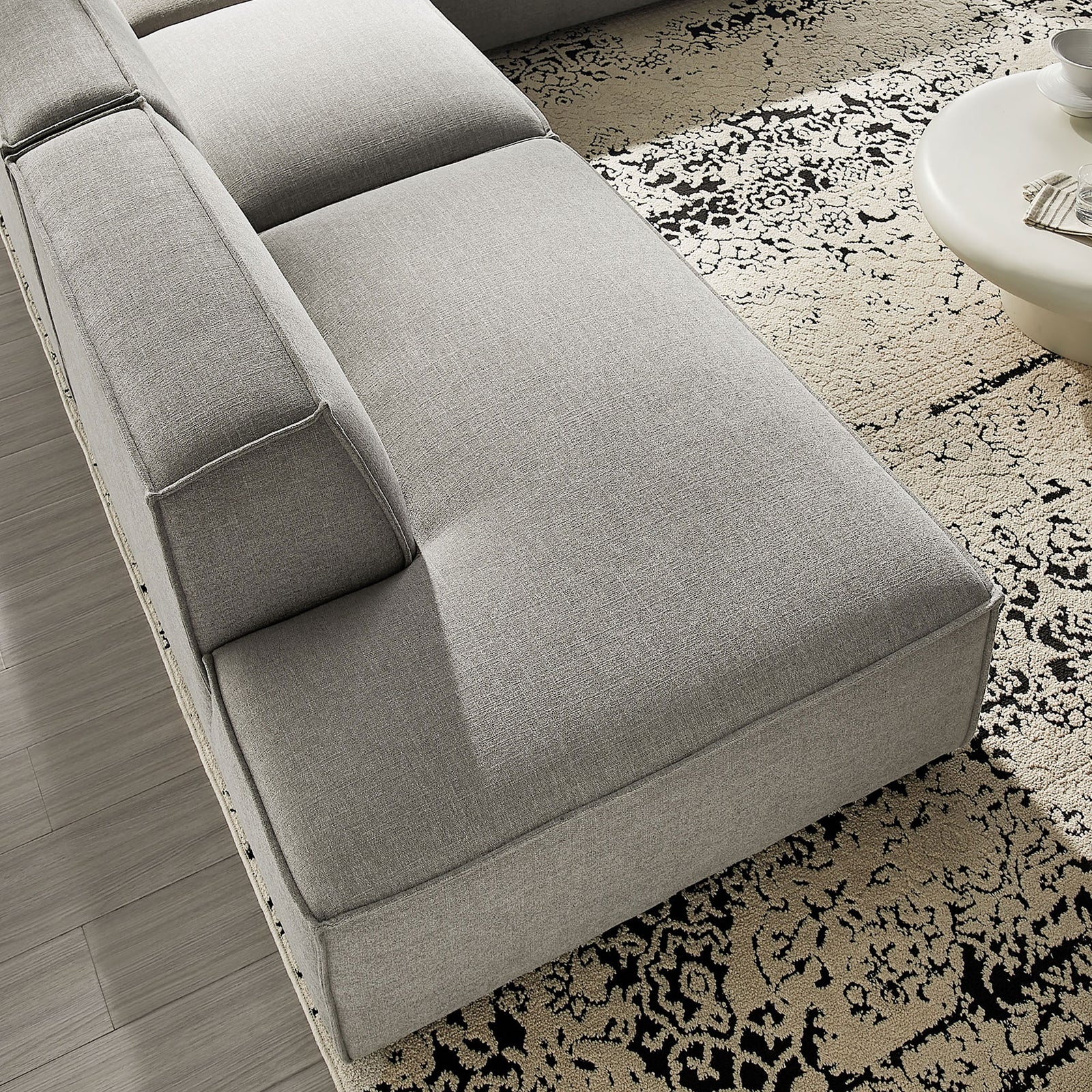 Chaise cushion on pewter sectional showcasing smooth performance fabric and plush padding || EEI-7413-PEW || detail_room