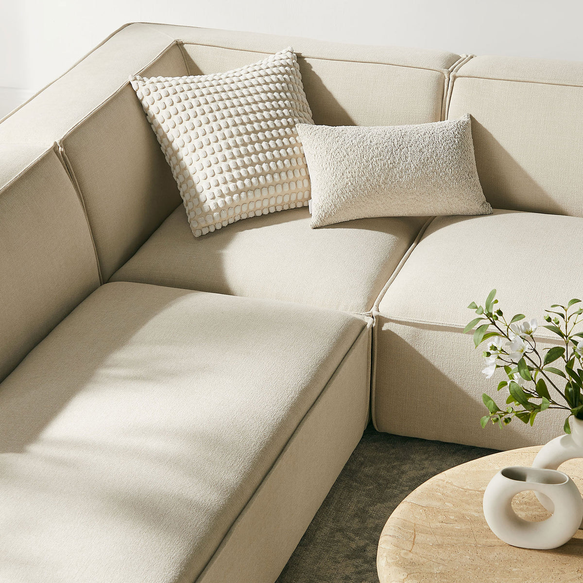 Soft ecru performance cushions paired with textured accent pillows create an inviting, cozy corner for relaxing. || EEI-7415-ECR || detail_room