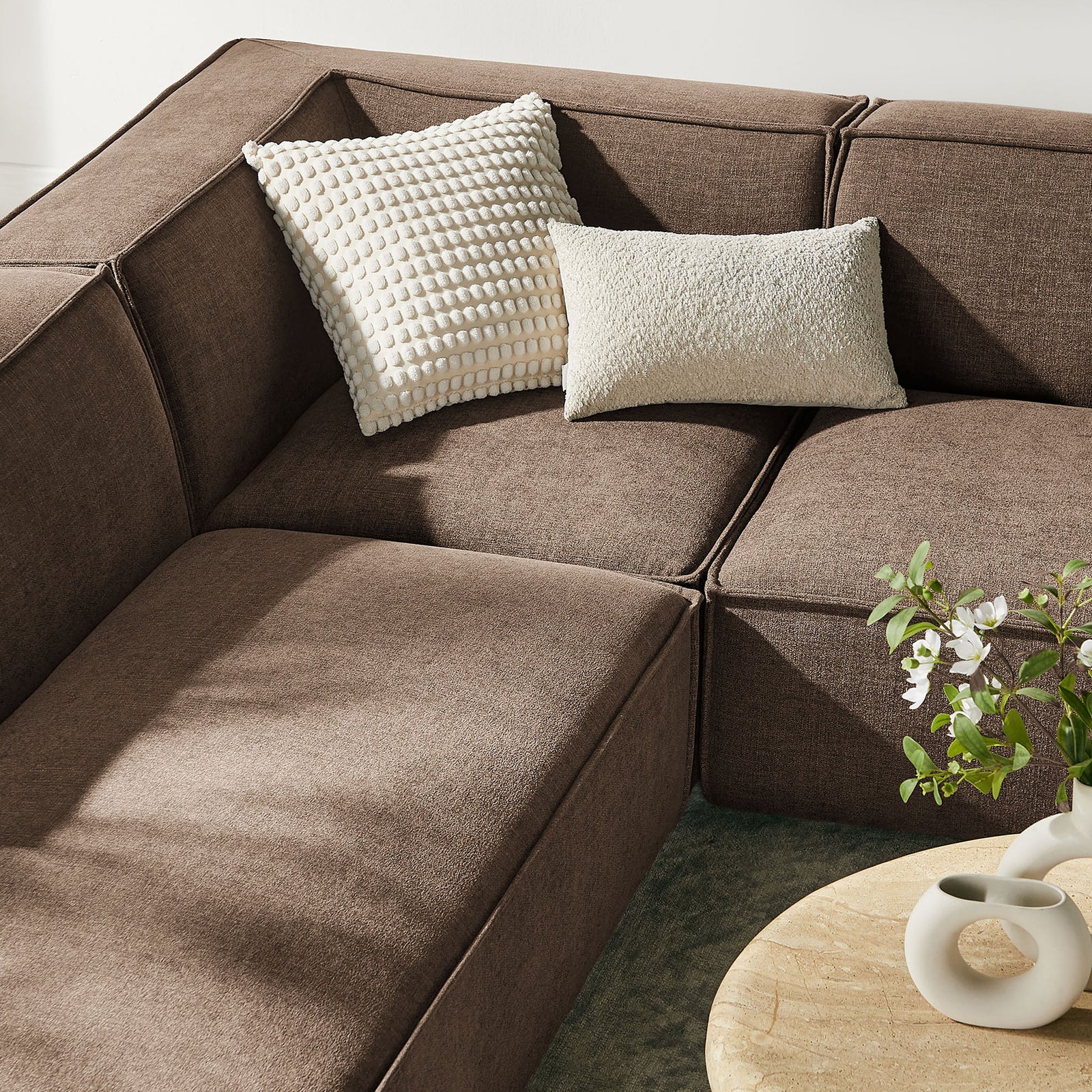 Mocha sectional corner styled with textured cream accent pillows. || EEI-7415-MOC || detail_room