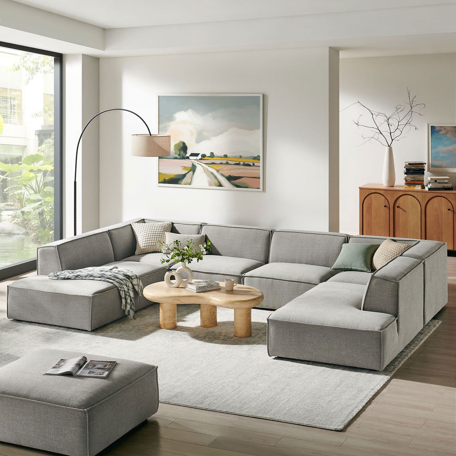 Pewter Restore modular sectional anchoring a bright modern living room with sculptural coffee table || EEI-7415-PEW || front_angle_room