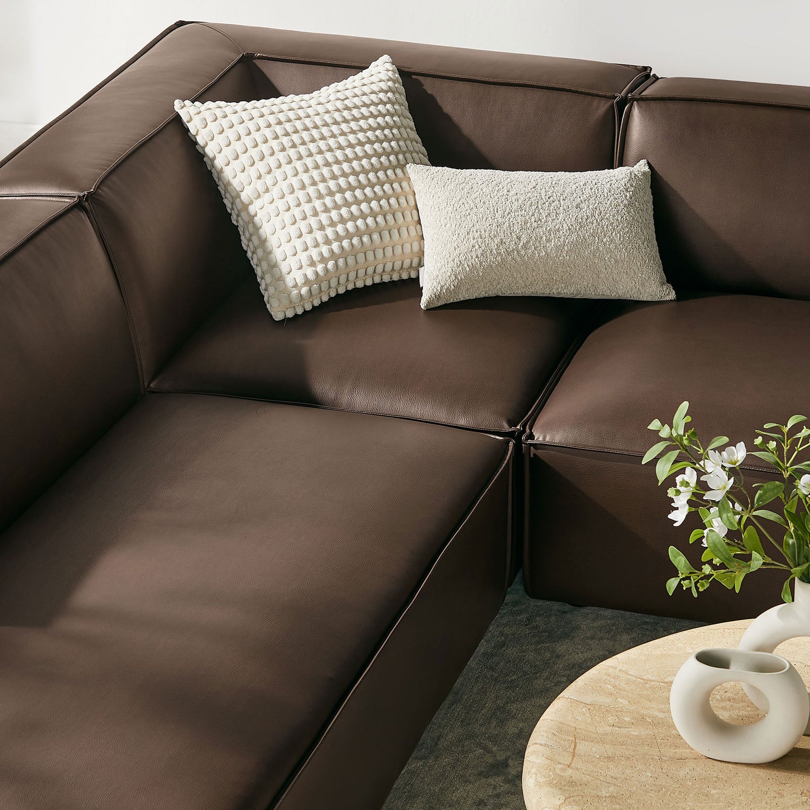 Soft espresso vegan leather cushions paired with textured accent pillows create an inviting lounge corner || EEI-7416-ESP || detail_room