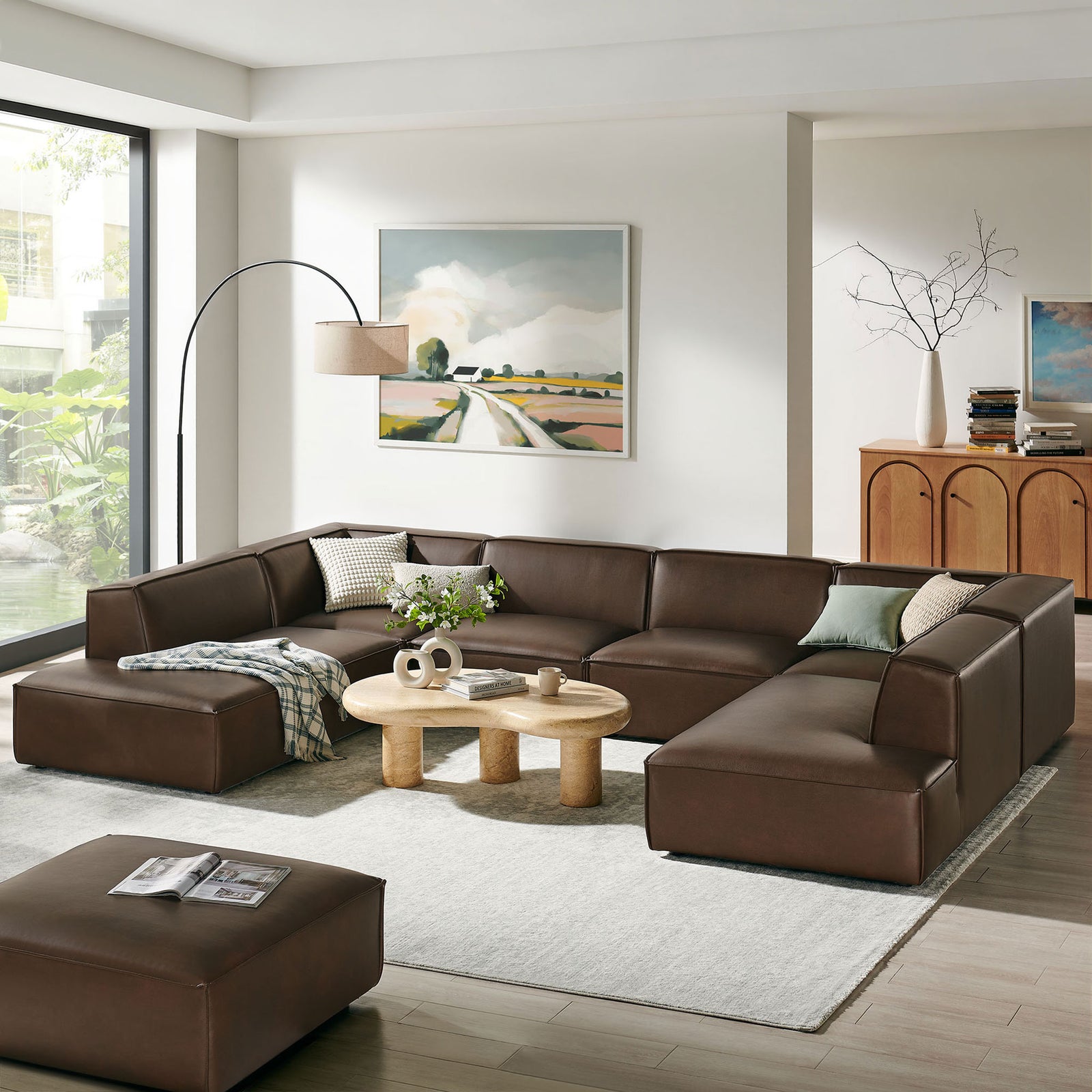Expansive U-shaped espresso vegan leather sectional defines a bright living room with relaxed, low-profile comfort || EEI-7416-ESP || front_angle_room