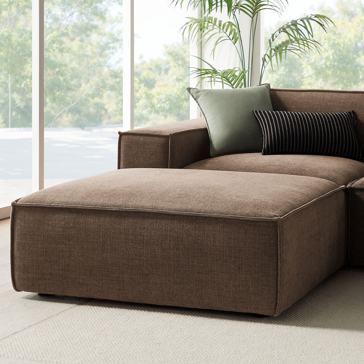 Relaxed chaise end of the mocha sectional with generous ottoman and layered throw pillows || EEI-7417-MOC || detail_room