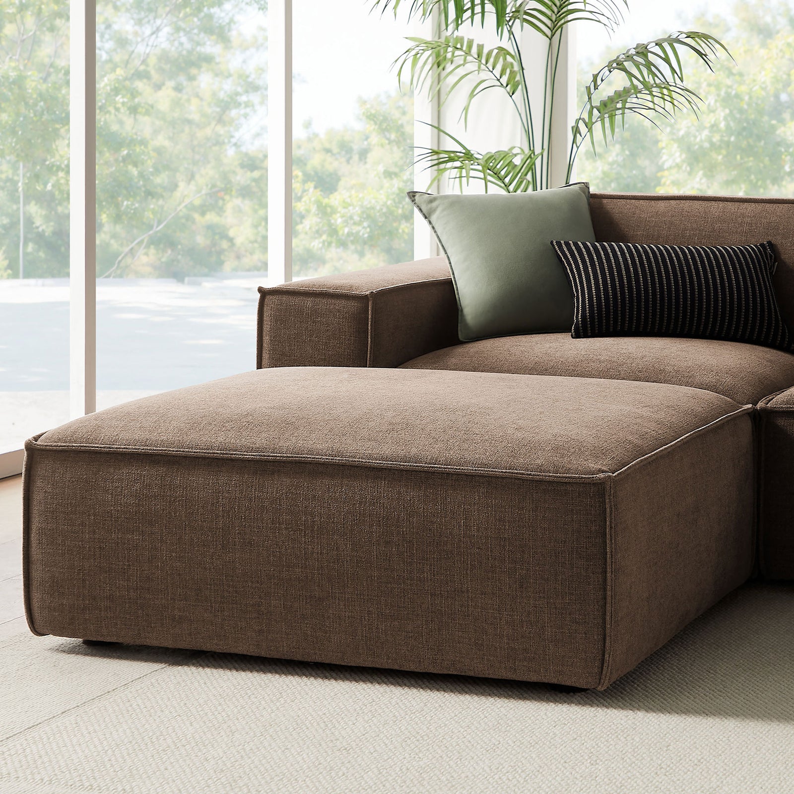 Relaxed chaise end of the mocha sectional with generous ottoman and layered throw pillows || EEI-7417-MOC || detail_room