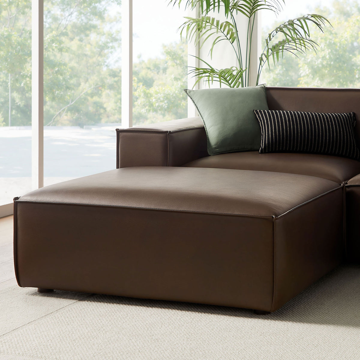 Espresso chaise end of the modular sectional styled with accent pillows for relaxed lounging || EEI-7418-ESP || detail_room