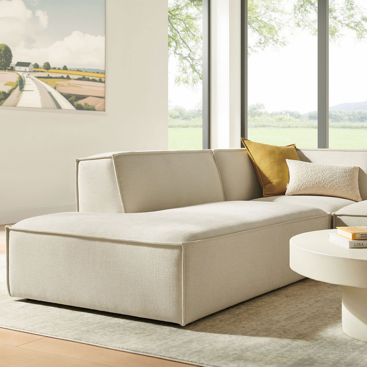 Chaise end of the modular sectional in a bright room, offering extra legroom and lounge-worthy comfort || EEI-7419-ECR || front_angle_partial_room