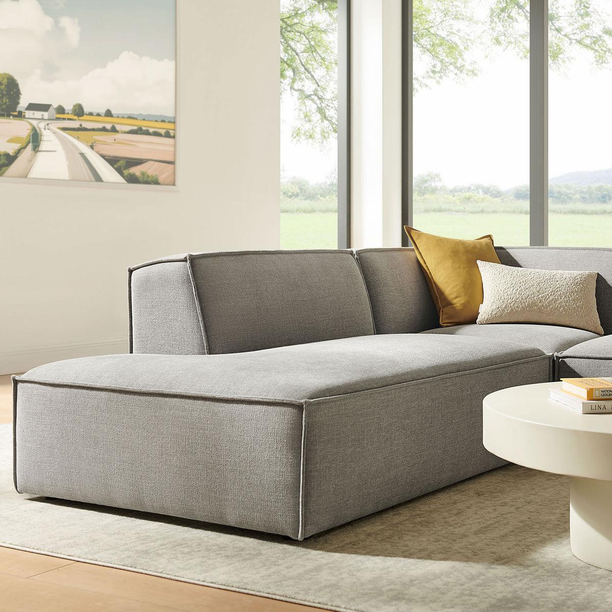 Left-facing chaise lounge section in pewter fabric, accented with layered throw pillows in a bright living room. || EEI-7419-PEW || front_angle_partial_room