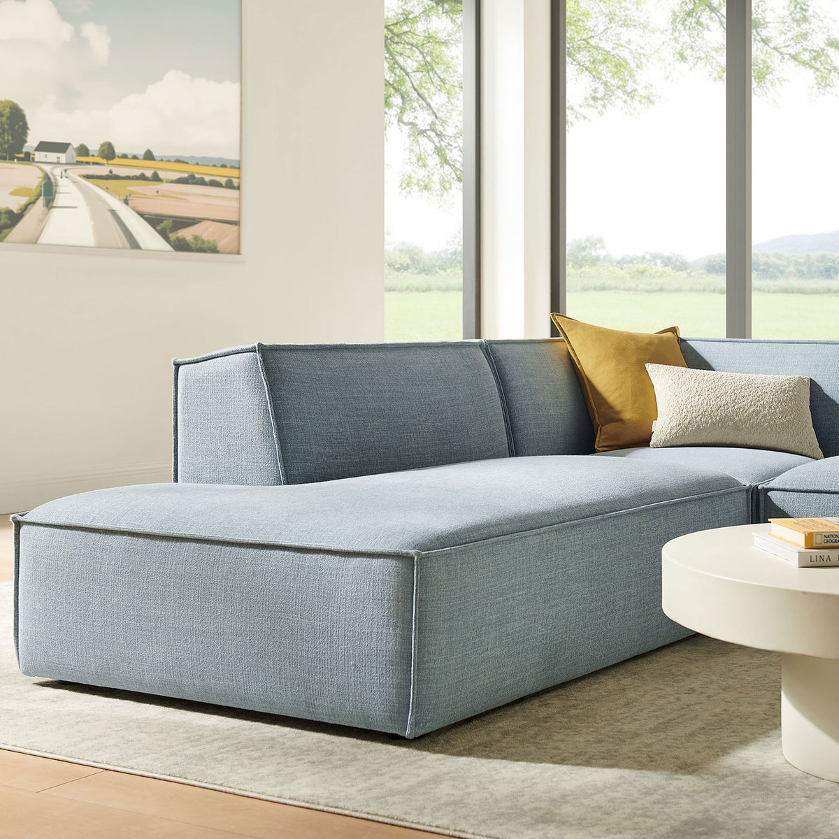 Sky blue chaise module with plush seat and tailored piping, styled with accent pillows for cozy lounging || EEI-7419-SKY || front_angle_partial_room