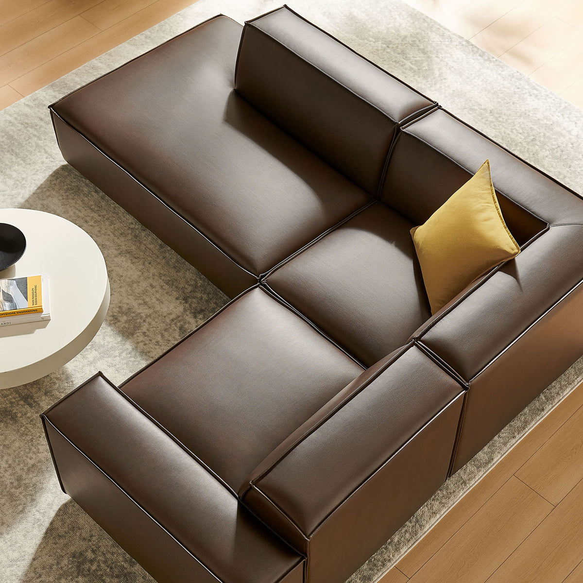 Angled overhead view of espresso vegan leather sectional with accent pillow and modern decor || EEI-7420-ESP || top_angle_room
