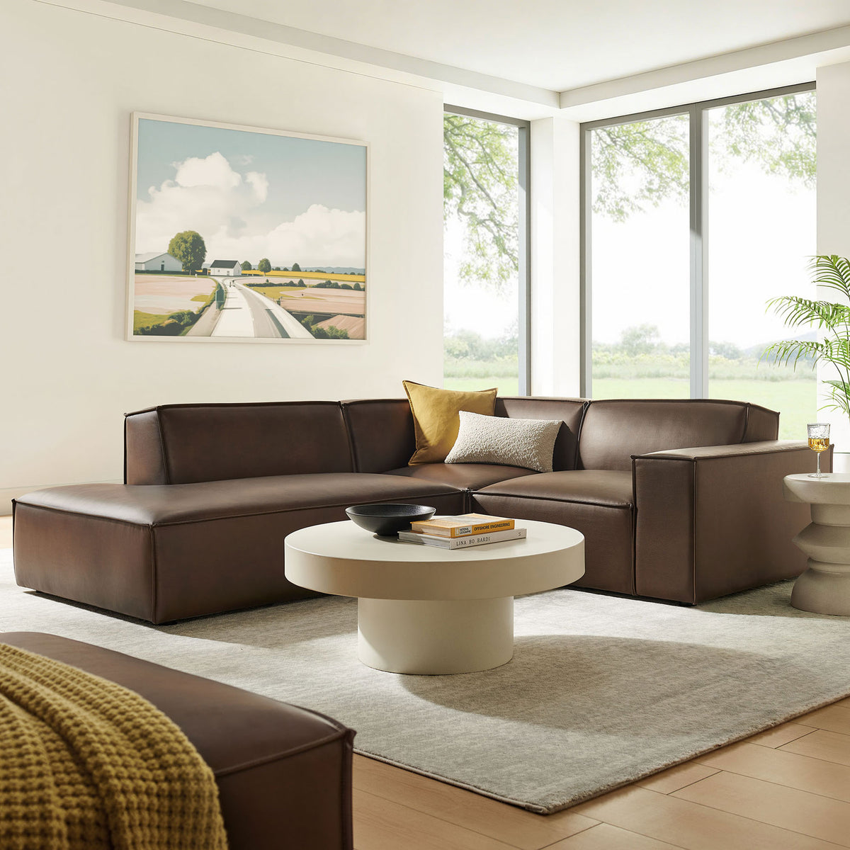 Espresso vegan leather L-shaped sectional in airy living room with round coffee table and rug || EEI-7420-ESP || front_angle_room
