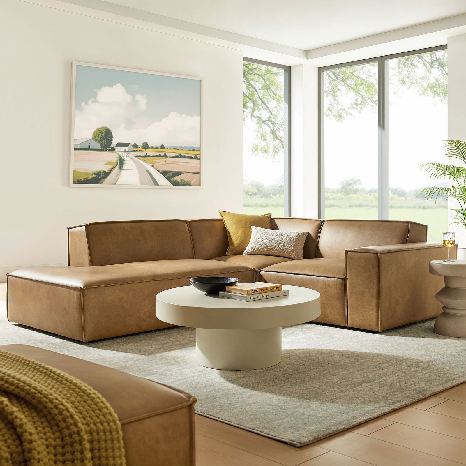Toast vegan leather left-facing L-shaped sectional arranged in a sunlit modern living room with soft neutrals || EEI-7420-TST || front_angle_room