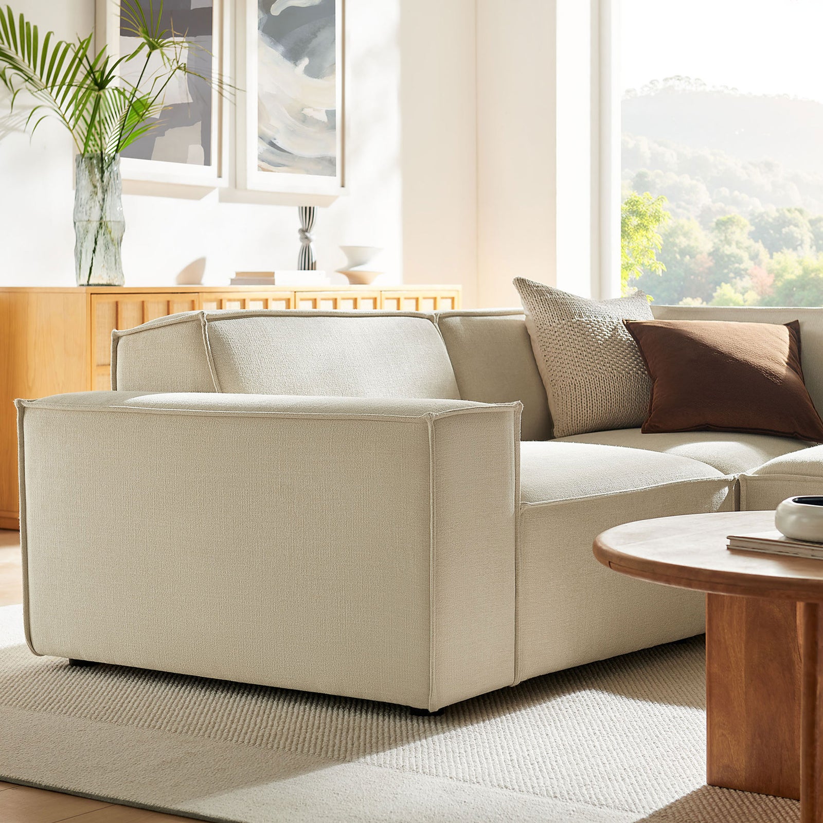 Left-arm end of the modular sectional in a serene living room, showcasing tailored lines and soft texture || EEI-7421-ECR || front_angle_partial_room