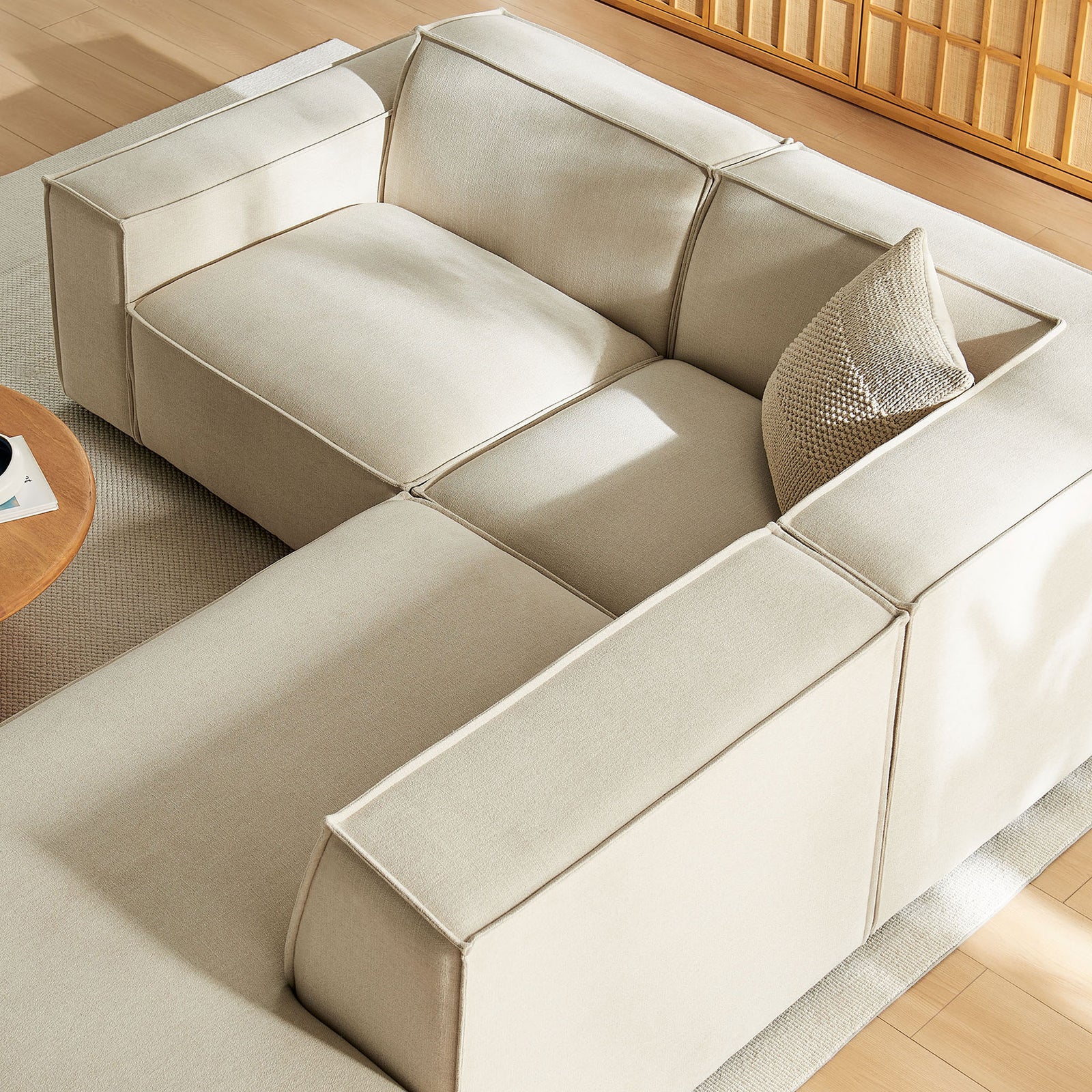 Expanded view of the modular sectional in an airy living room, emphasizing wide seats and generous chaise || EEI-7421-ECR || top_angle_room