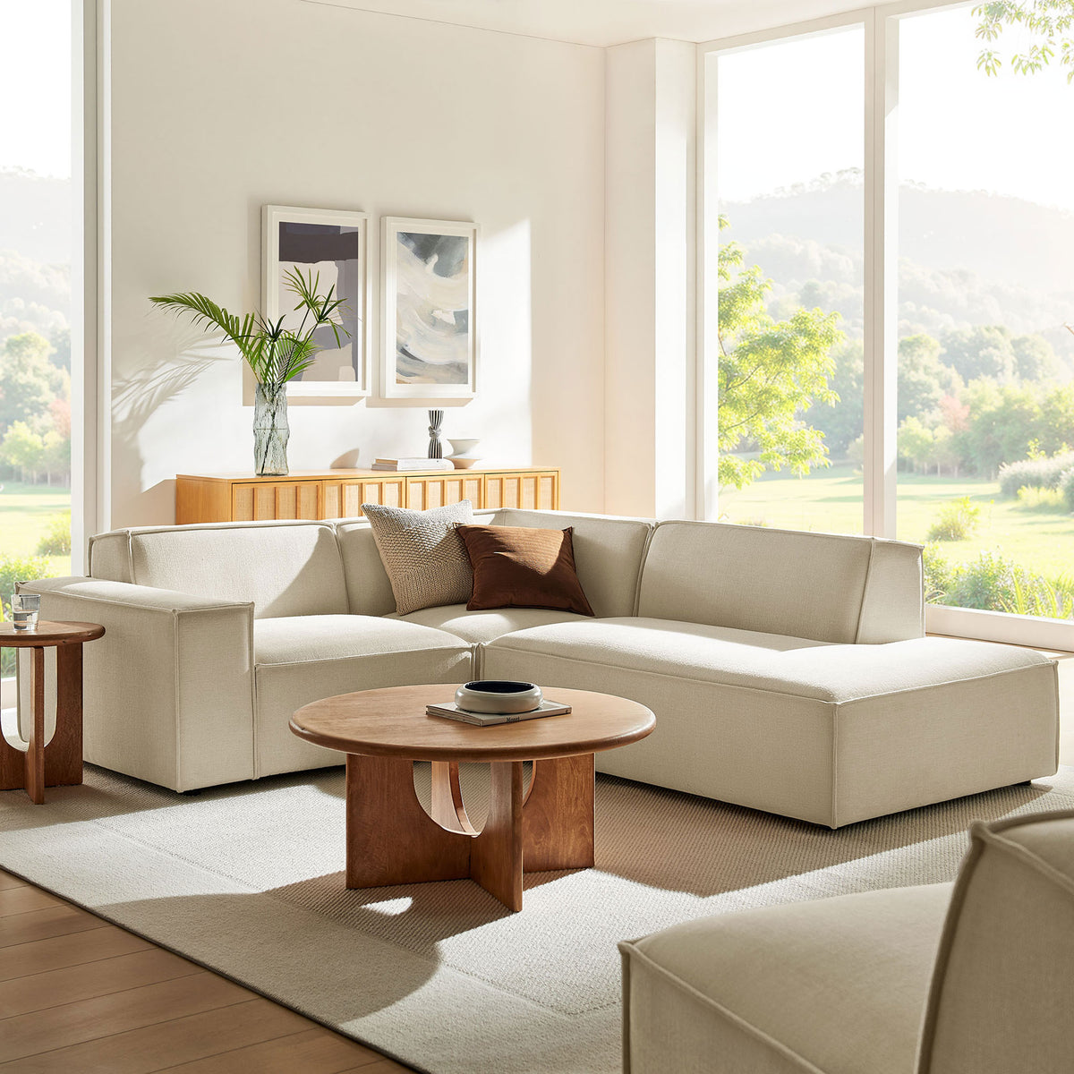 Neutral ecru modular sectional styled in a bright living room with layered pillows and warm wood accents || EEI-7421-ECR || front_angle_room