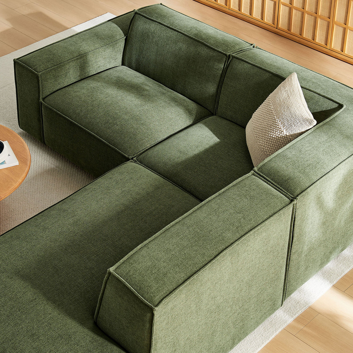 Tuftless seat cushions and tailored piping on the green modular sectional, styled with a knit accent pillow || EEI-7421-FOL || detail_room