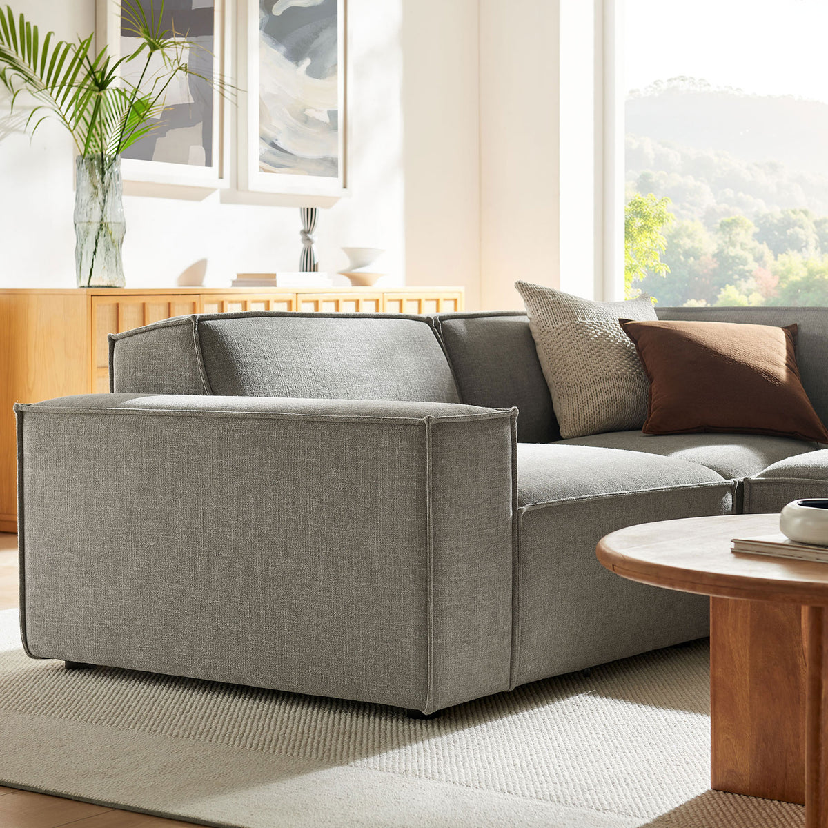 Close-up of wide track arm and supportive cushions on the pewter modular sectional sofa. || EEI-7421-PEW || detail_room