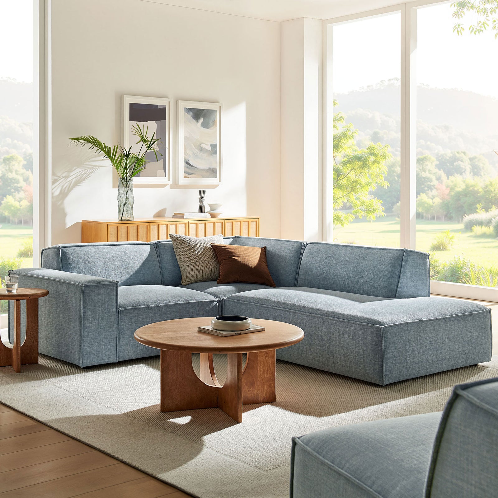 Relaxed sky blue sectional anchors this airy living room, offering deep cushions and a long lounging chaise || EEI-7421-SKY || front_angle_room