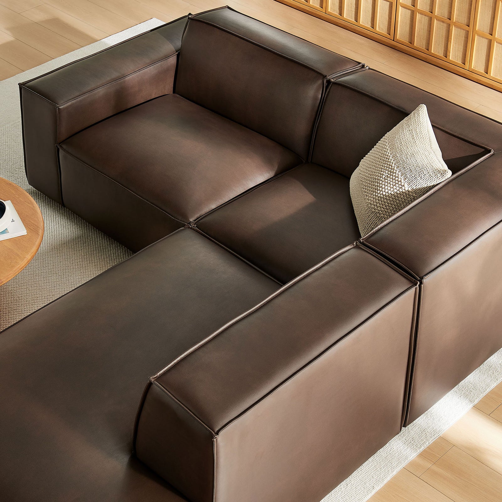 Angled overhead view of espresso vegan leather sectional styled with neutral throw pillow || EEI-7422-ESP || top_angle_room
