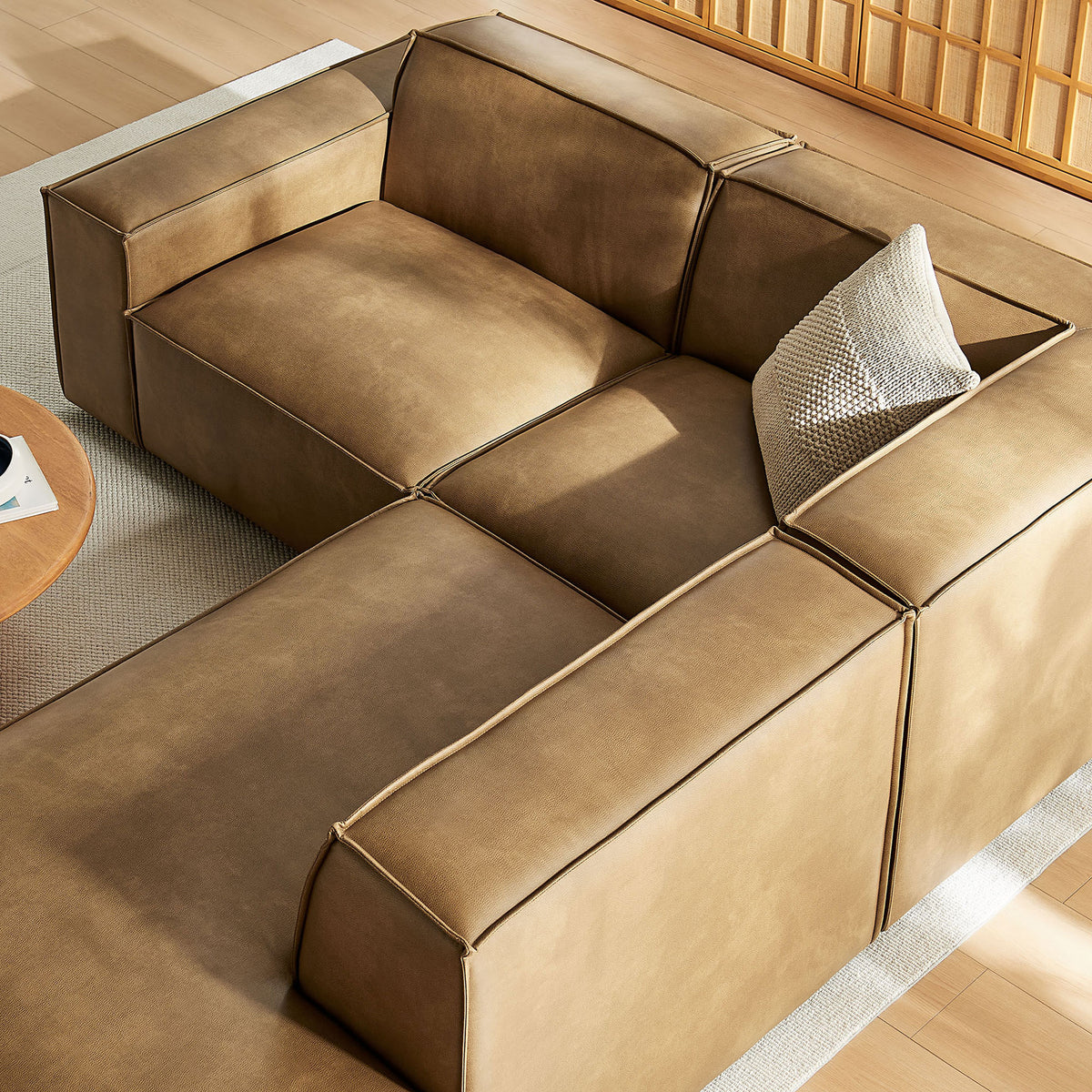 Modular toast vegan leather sectional with accent pillows showcasing the spacious seating configuration || EEI-7422-TST || detail_room