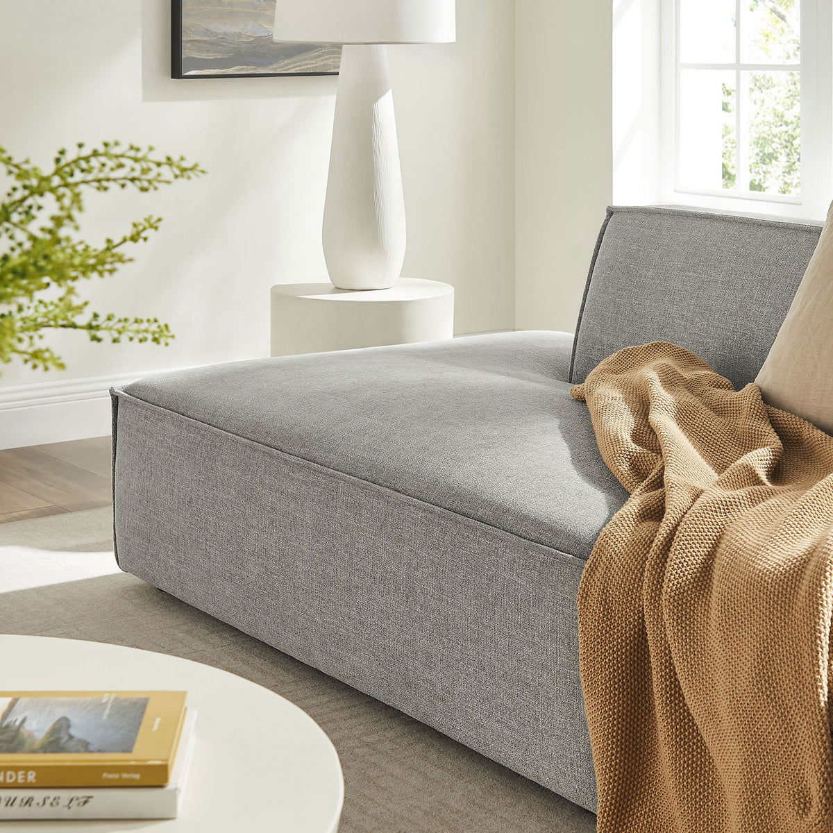 Cozy pewter chaise seat styled with a soft throw blanket in a bright living room setting || EEI-7423-PEW || detail_room