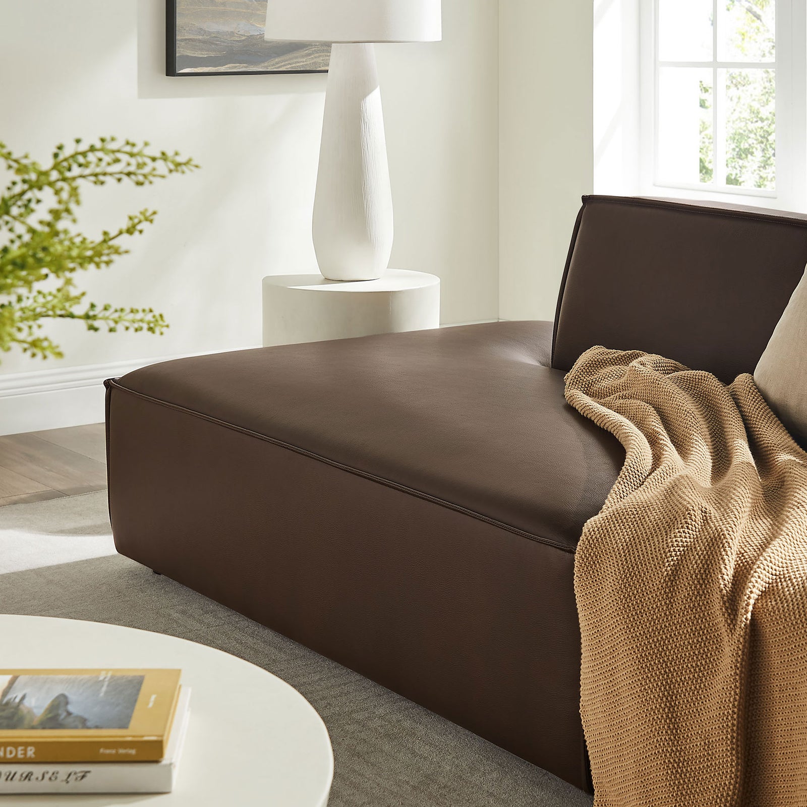 Close-up of the espresso vegan leather seat with plush cushion, cozy throw, and modern decor accents || EEI-7424-ESP || detail_room
