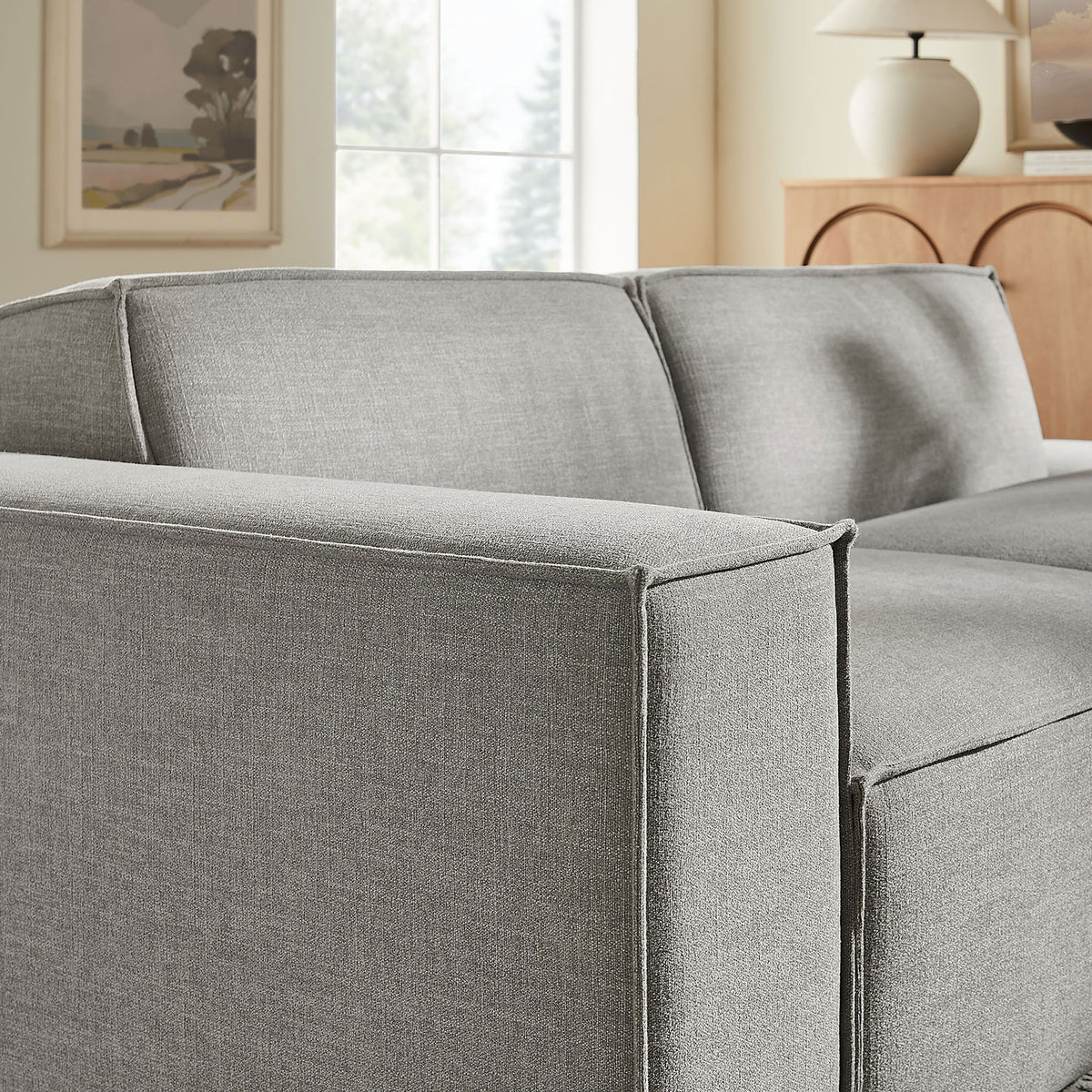 Close-up of loveseat arm and back cushions with tailored French piping in pewter performance fabric. || EEI-7425-PEW || detail_room