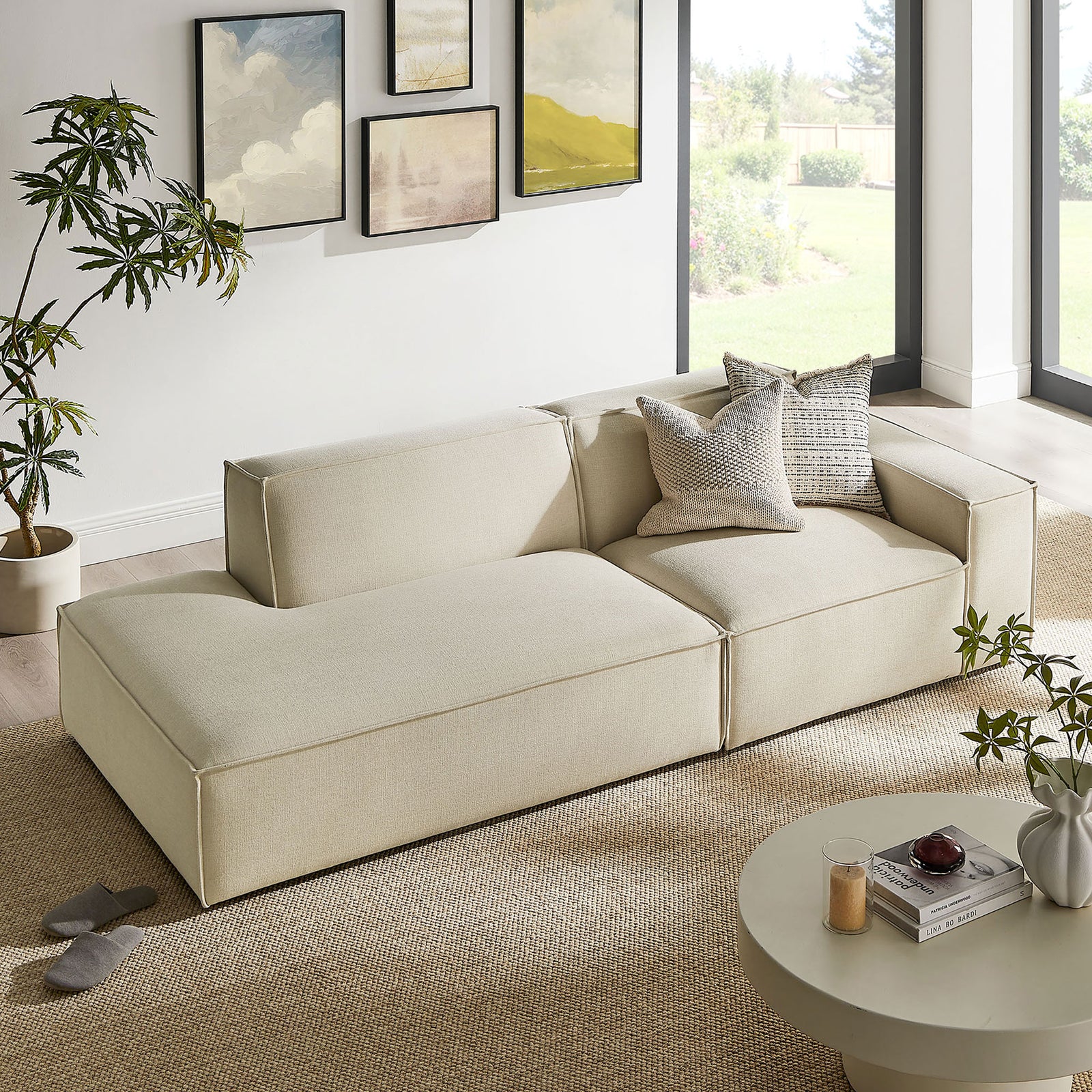 Ecru modular loveseat arranged in a sunlit living room with textured rug, plants, and modern decor || EEI-7427-ECR || front_angle_room