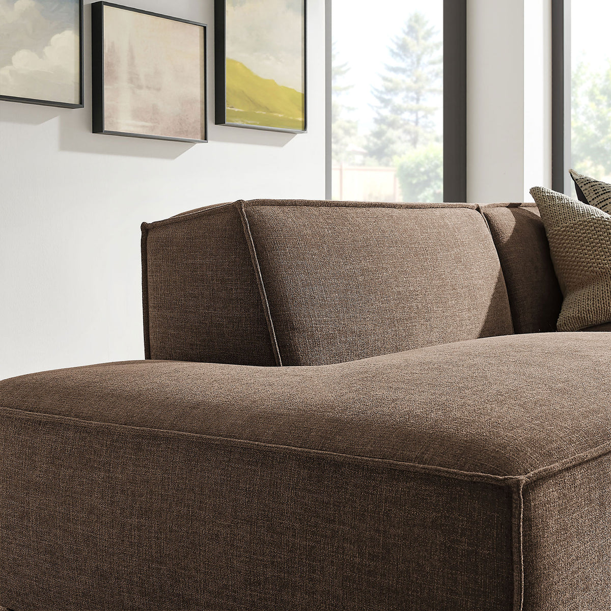 Curved back cushion and soft mocha upholstery creating a cozy, enveloping lounge feel || EEI-7427-MOC || detail_room