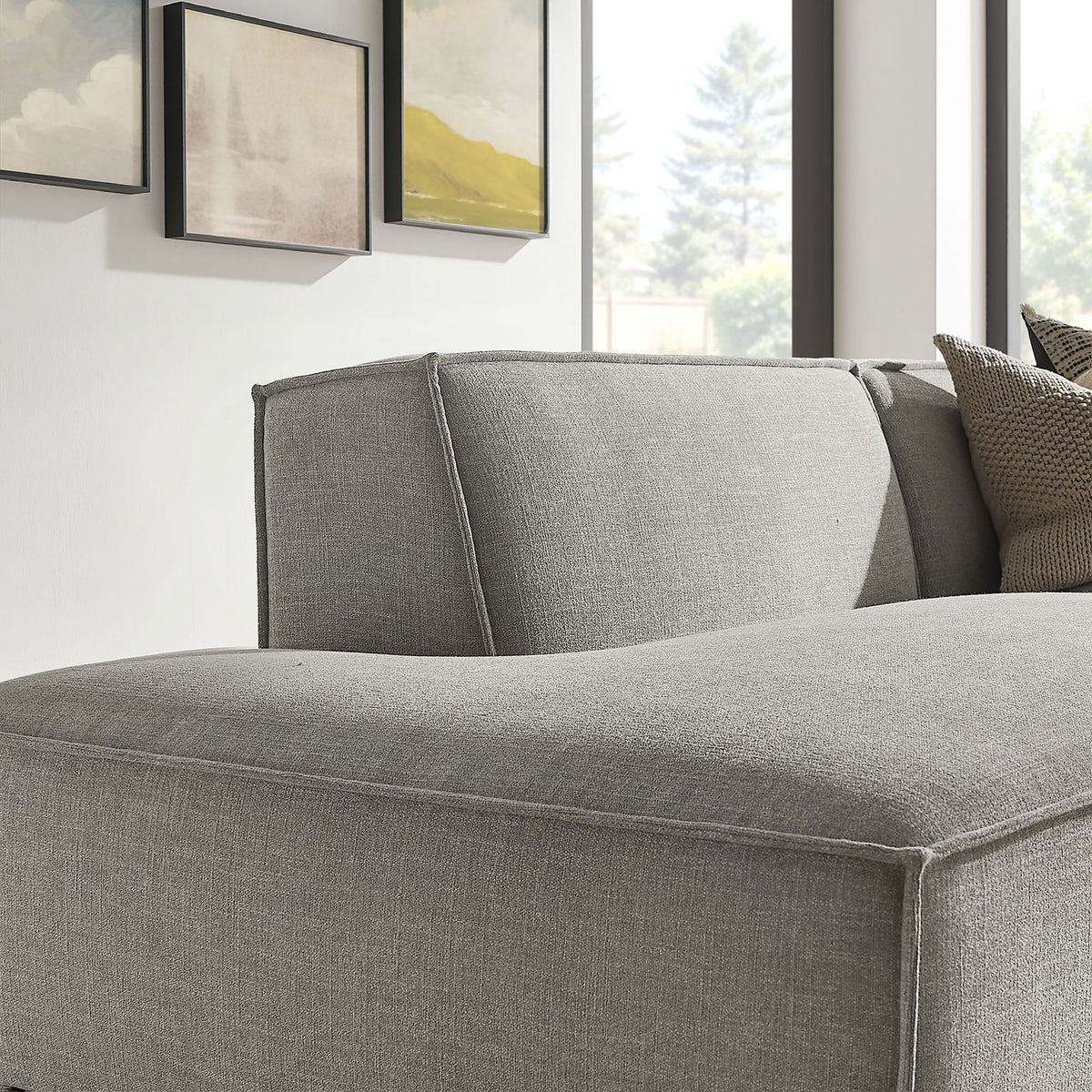 Close-up of chaise backrest with soft pewter upholstery and tailored seams in a bright room. || EEI-7427-PEW || detail_room