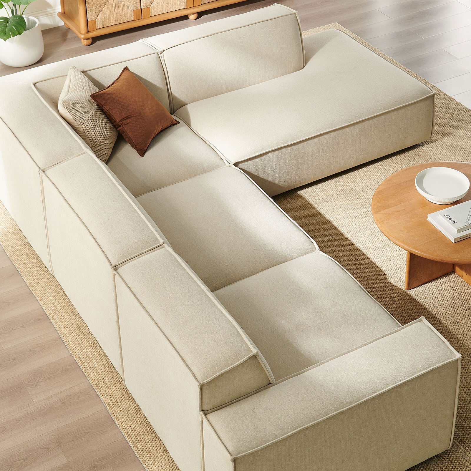 Inviting corner of the Restore sectional with plush cushions and layered neutral accent pillows || EEI-7429-ECR || detail_room