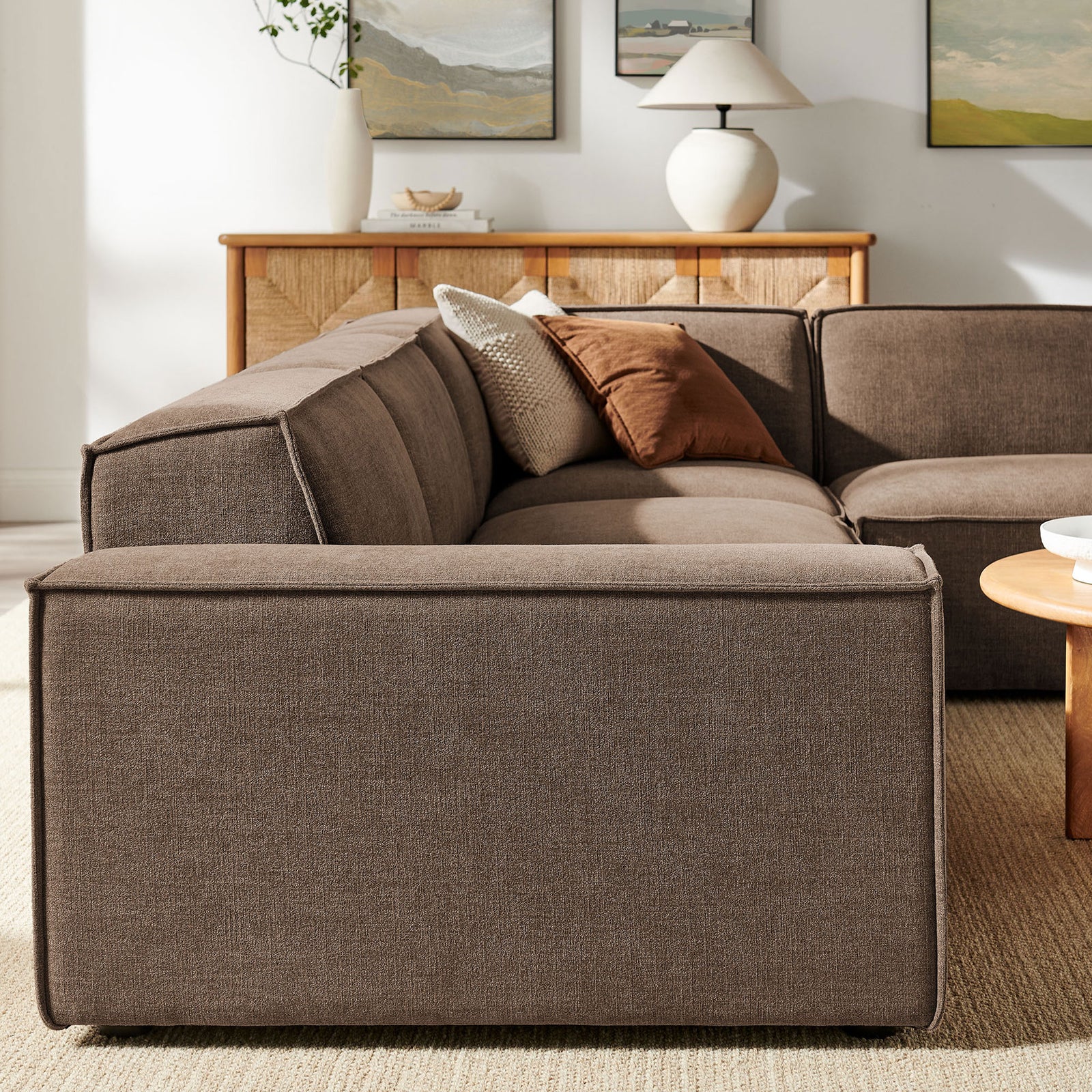 Upholstered back and low profile arms create a sleek silhouette against the living room wall || EEI-7429-MOC || side_room