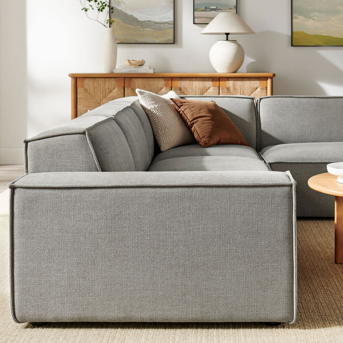 Back and arm profile of the modular sectional showing tailored piping and smooth performance fabric || EEI-7429-PEW || back_angle_room