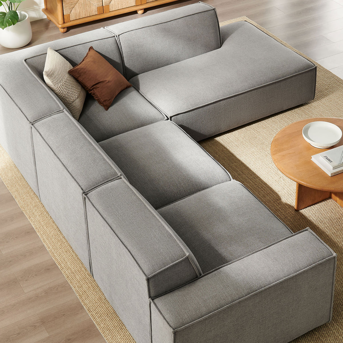 Generous seat cushions and extended chaise form an inviting lounging nook on this pewter modular sofa || EEI-7429-PEW || top_angle_room