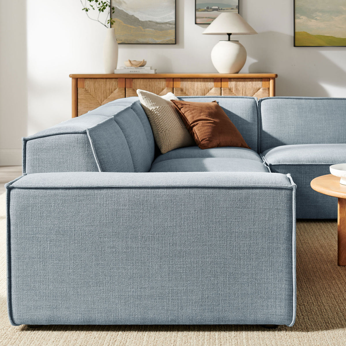 Sky blue modular sofa showcasing clean-lined back cushions and tailored piping detail || EEI-7429-SKY || detail_room