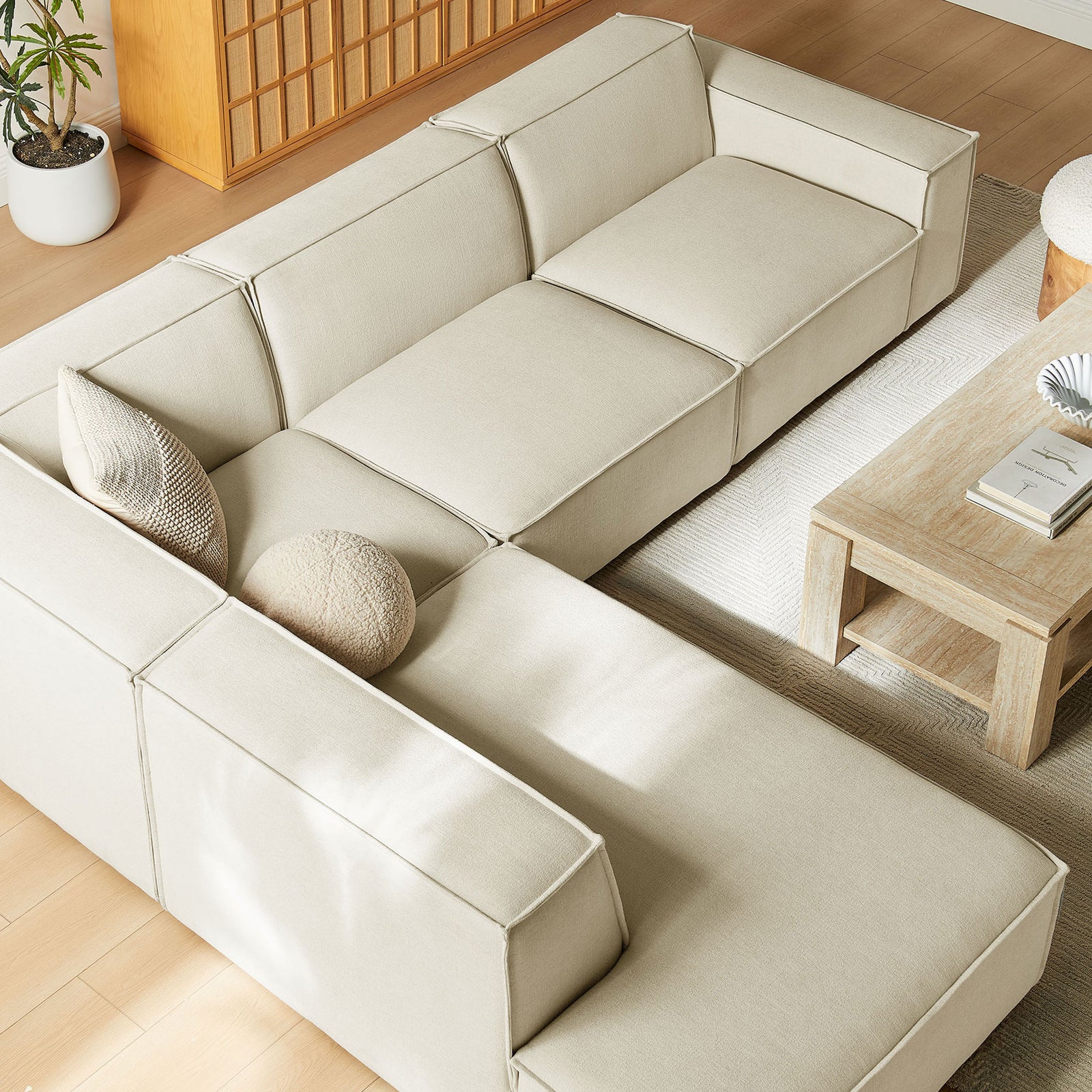Spacious chaise lounge and seat cushions of the Restore sectional layered with soft, textured pillows || EEI-7431-ECR || detail_room