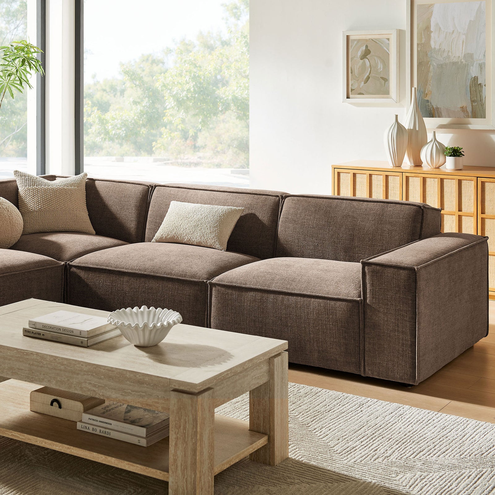 Relaxed lounge seating with plush mocha cushions and subtle French piping detail || EEI-7431-MOC || front_angle_room