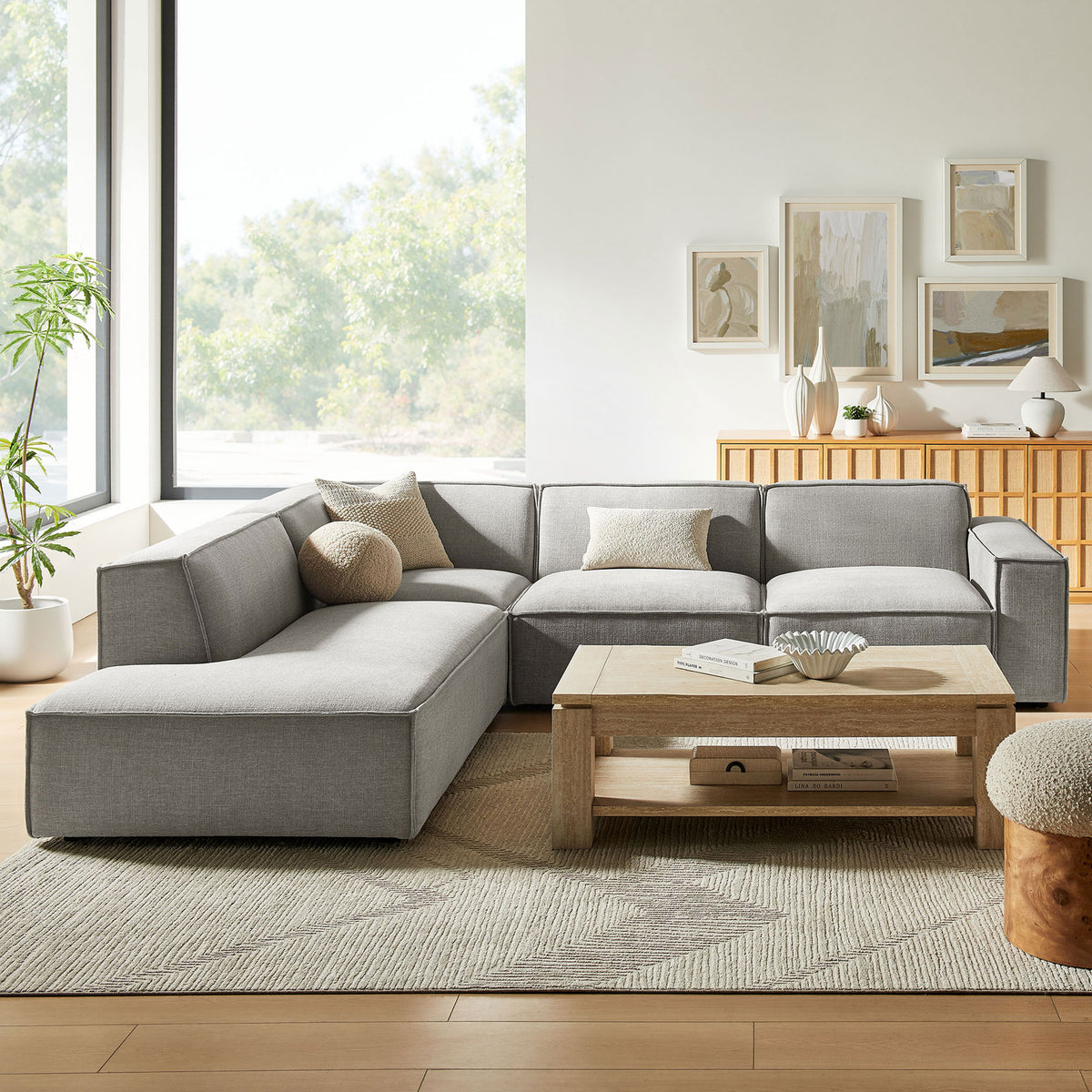 Spacious pewter L-shaped sectional anchored in a bright living room with cozy neutral accent pillows || EEI-7431-PEW || front_room