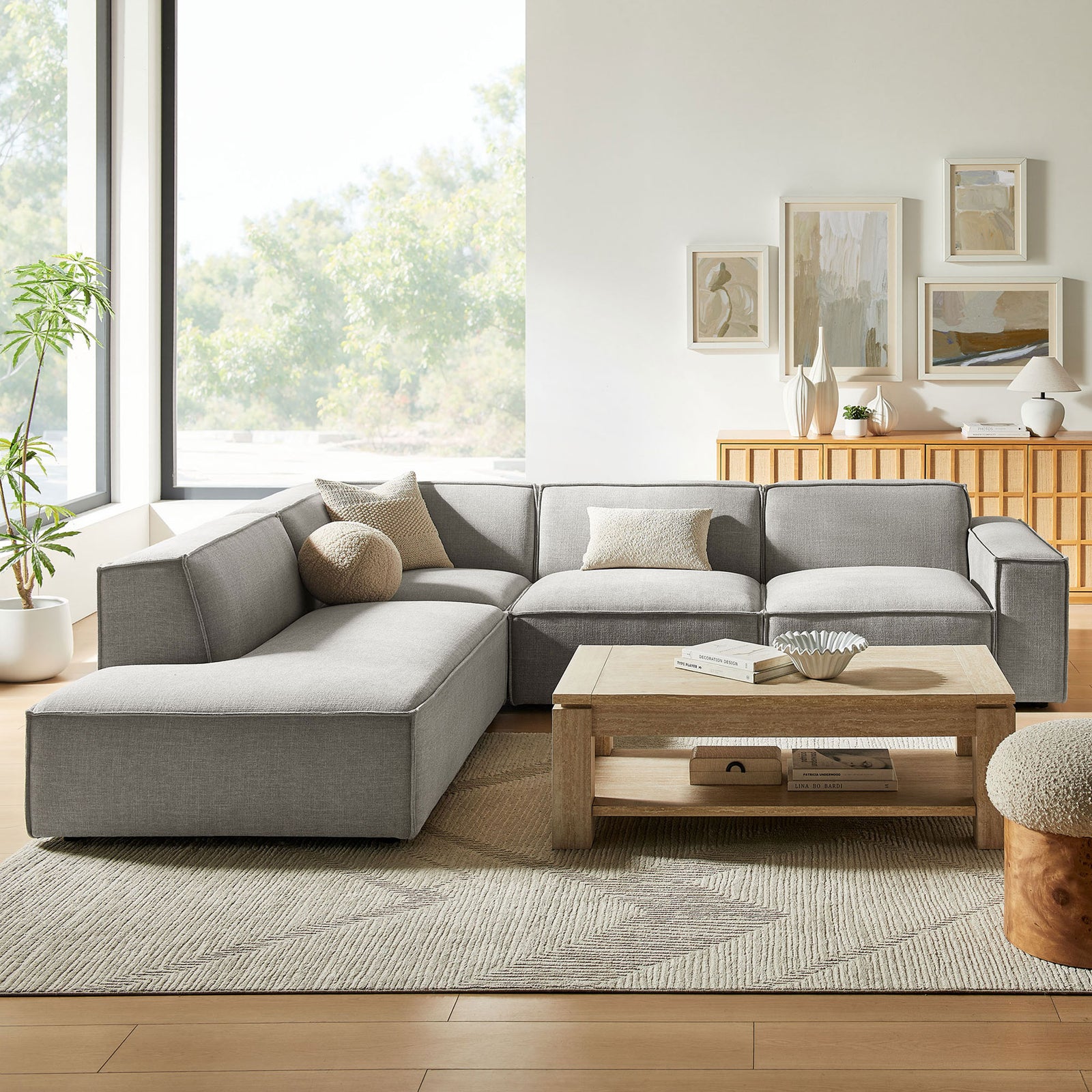 Spacious pewter L-shaped sectional anchored in a bright living room with cozy neutral accent pillows || EEI-7431-PEW || front_room