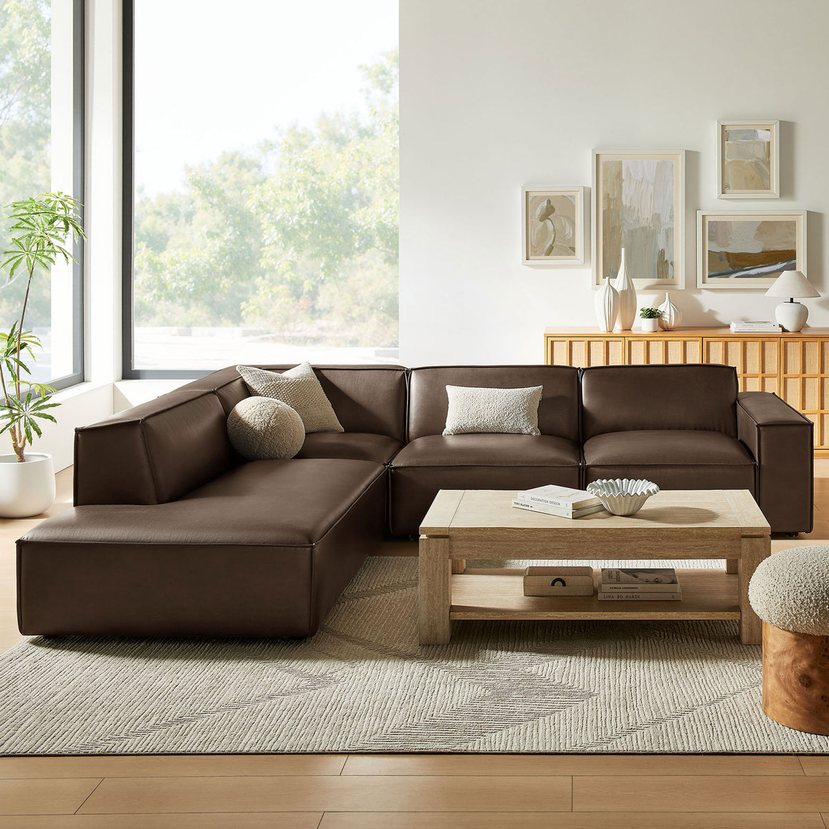 Espresso vegan leather L-shaped sectional styled in a bright living room with neutral rug, wood coffee table, and accent pillows || EEI-7432-ESP || front_room